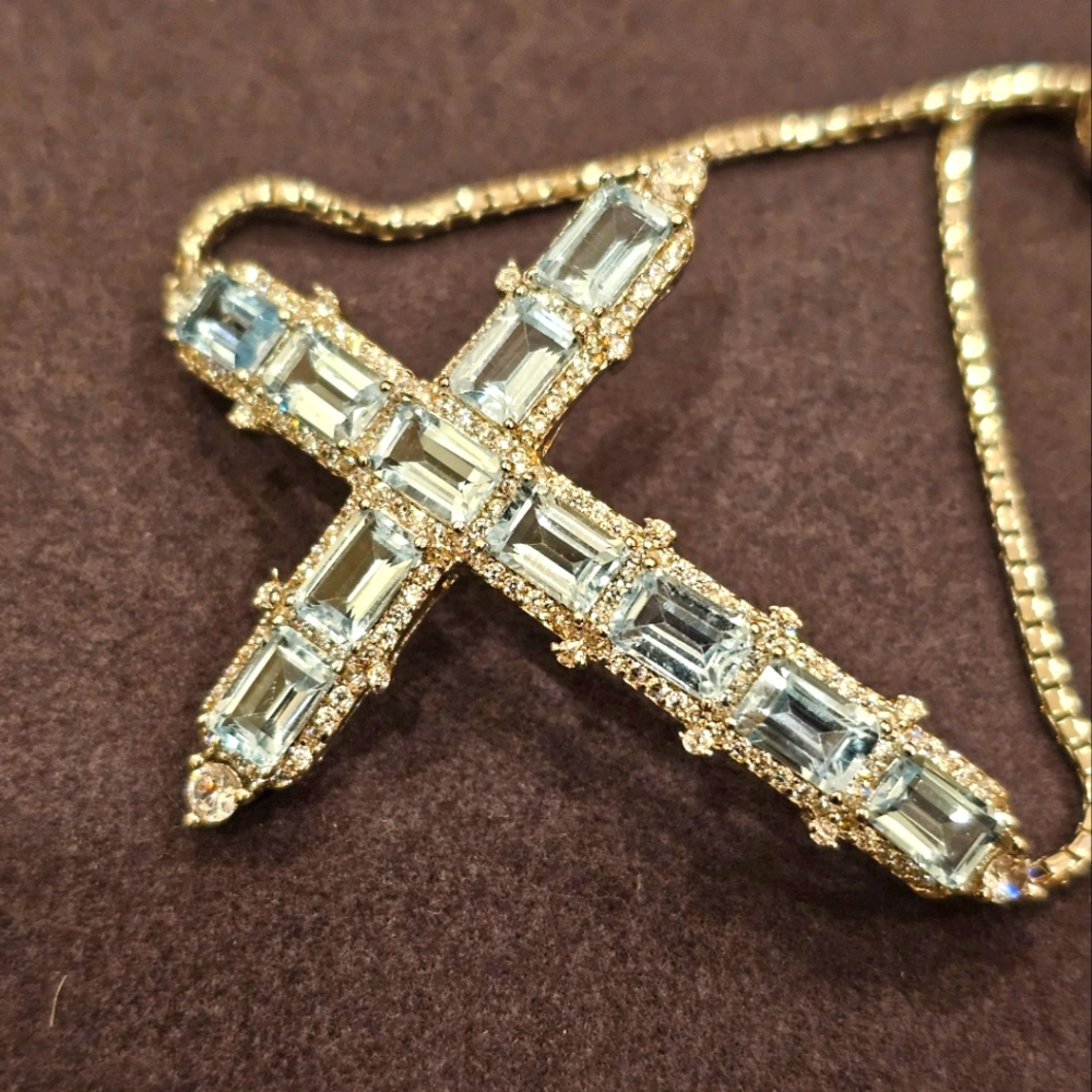 Sky blue topaz adjustable Cross bracelet with bolo closure. Sterling silver